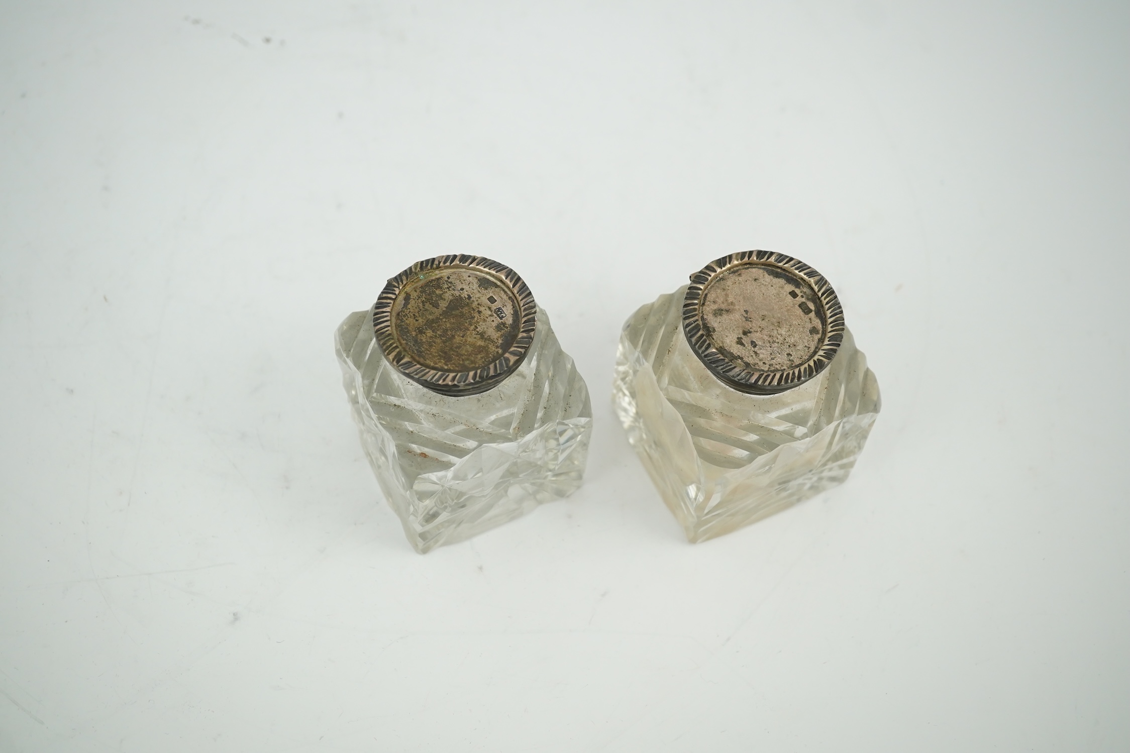 A pair of silver mounted cut glass inkwells, maker JT, height 66mm. Condition - fair to good